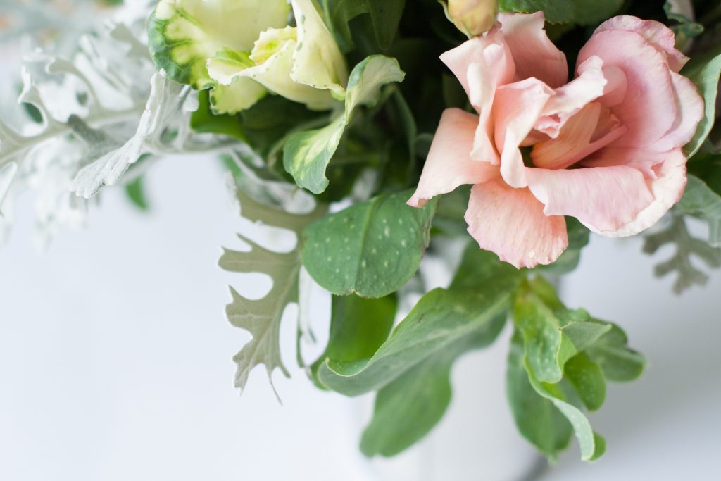 Vase of pink and green flowers. 